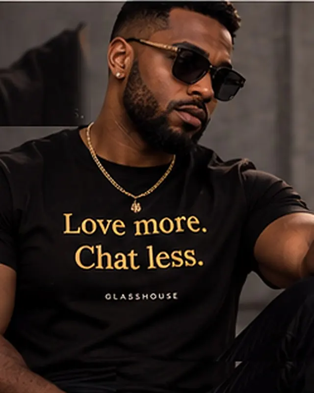 The Creed Tee in black, worn: Love more. Chat less. Glasshouse